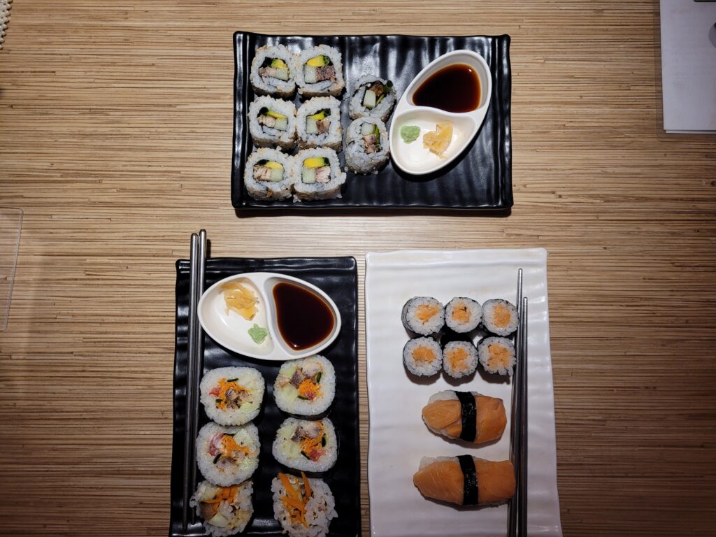 Top Plate: Inside Out Sushi. Left Plate: Futomaki Smoked Fish. Right Plate: Two pieces of Salmon Nigiri, Maki Smoked Fish.